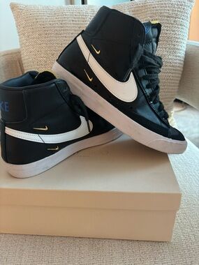 Nike Black and White High-Top Sneakers with Gold Accents